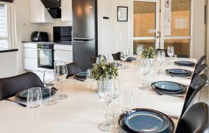 a long table with glasses and plates on it at Nice Home In Haderslev With Sauna in Haderslev