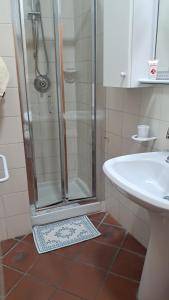 a bathroom with a shower and a sink at Caterina House in San Lucido +17 photos