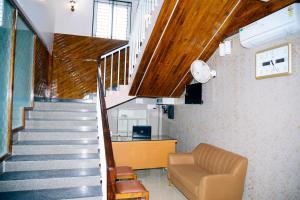 a staircase with a couch and a stair case at Aldur Residency in Aldūr