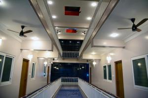 a hallway with two ceiling fans in a building at Aldur Residency in Aldūr