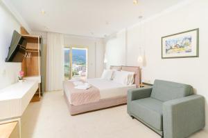 a large bedroom with a bed and a chair at Synthea Suites in Chrysi Ammoudia +35 photos