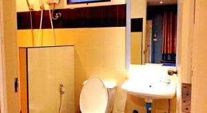 a bathroom with a toilet and a sink at Zigzag Resort in Yasothon