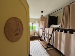 a room with a bunk bed and a room with a sign at Maceda Surf Camp in Maceda +27 photos
