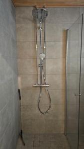 a shower in a bathroom with a glass door at Fabbrica's new and elegant apartment in Turku