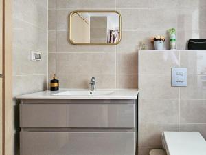a bathroom with a sink and a mirror at Mamad Family Friendly New Condo By Feelhome in Yerushalayim +16 photos