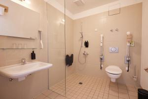 a bathroom with a shower and a toilet and a sink at ahead burghotel in Lenzen +21 photos