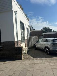 a car parked in front of a house at The Velvet Suite Alkmaar in Alkmaar +1 photo
