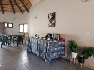 a table with a table cloth on it in a room at The Huts in Vila Praia Do Bilene
