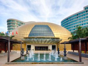 a large building with a fountain in front of it at Pullman Vung Tau in Vung Tau