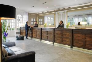 a lobby with people standing at a reception desk at Citywest Hotel in Citywest