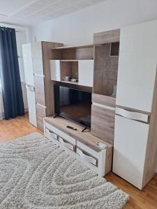 a living room with a entertainment center with a fireplace at Vibe Apartament 17 in Galaţi