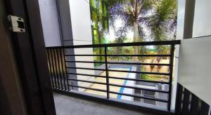 a view of a palm tree from a window at Ecoland 88 Apartelle and Suite near SM Davao in Davao City