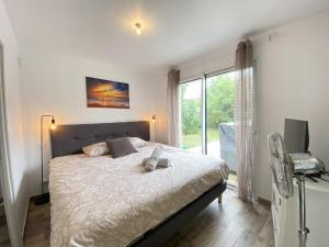 a bedroom with a bed and a large window at La Maison Moderne - 6 pers - SPA - Piscine in Saint-Sauveur-dʼAunis +46 photos