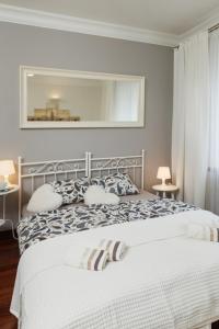 a bedroom with a bed and a mirror on the wall at Apartament Abrahama in Gdynia
