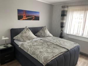 a bedroom with a bed and a bridge picture on the wall at Ferienwohnung Hubertus in Irsch