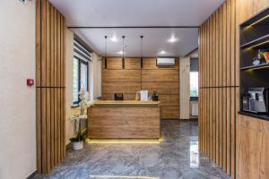 an office with wooden walls and a reception desk at TAU 28 Hotel in Almaty
