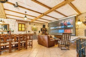 a large living room with a large screen in a building at Casa Turística la Almunia in Castellanos de Moriscos