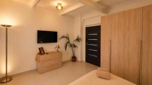 a living room with a tv on the wall at Aime's House in Sliema
