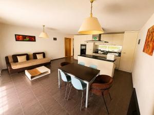 a kitchen and a living room with a table and chairs at Skender's Apartment in Interlaken +7 photos