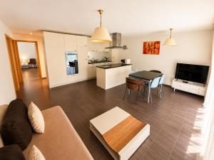 a living room and kitchen with a couch and a table at Skender's Apartment in Interlaken