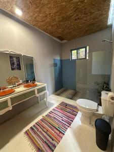 a bathroom with a toilet and a sink and a mirror at Maceda Surf Camp in Maceda