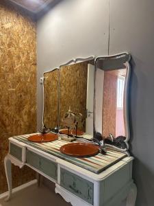a bathroom with a sink and a mirror at Maceda Surf Camp in Maceda