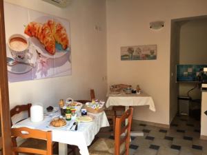 a dining room with a table with food on it at Hotel Patti in Golfo Aranci