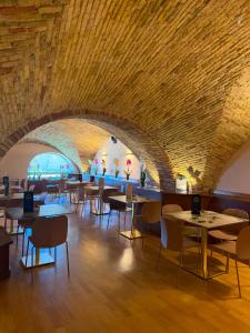 a dining room with tables and chairs and a brick ceiling at Hotel Santa Lucia in Termoli