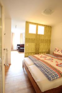 a bedroom with a bed and two windows at Gala Apartments - Country Oasis in Pettenbach in Pettenbach