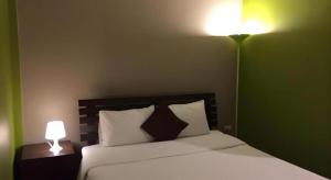 a bedroom with a bed with two lamps on it at Baan Chomphu in Prachuap Khiri Khan +52 photos