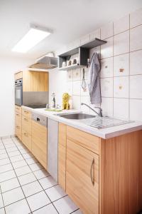 a kitchen with wooden cabinets and a sink at Monteurzimmer in Nordhausen