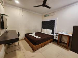 a bedroom with a bed with a white animal on it at Hotel Al Sana in Kolkata