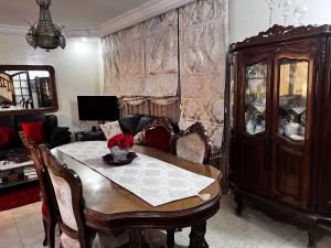 a living room with a table and a china cabinet at Dar Cirta in Sicca Veneria