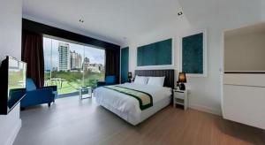 a bedroom with a large bed and a large window at Read River in Anping
