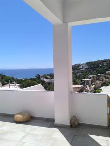 a room with a white wall and a large window at Vromolithos View House in Vromolithos