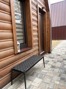 a black bench sitting outside of a building at Áčko in Oščadnica