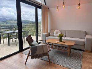 a living room with a couch and a table at Áčko in Oščadnica +39 photos