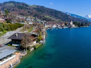 an aerial view of a town on the shore of a lake at Villa Alti Ländte in Oberhofen am Thunersee
