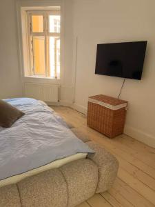 a bedroom with a bed and a flat screen tv at Hearthstone Atelier in Antwerp