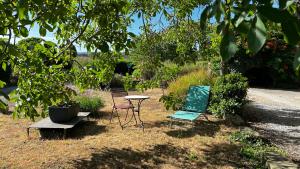 two chairs and a table and chairs in a yard at Virevent in Carcassonne +25 photos
