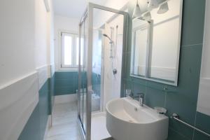 a bathroom with a sink and a shower at Residence Savoia in San Vito lo Capo +11 photos