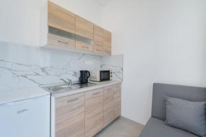 a kitchen with a sink and a microwave at Studios Tasos Bi 2 in Chrysi Ammoudia +15 photos