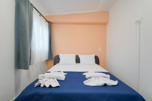 a bedroom with a bed with towels on it at Studios Tasos Bi 2 in Chrysi Ammoudia