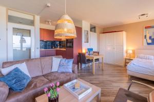 a living room with a couch and a table at Appartementencomplex Juliana 158 in De Koog