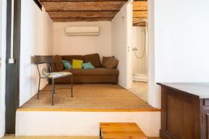 a living room with a couch and a chair at L'Oasis Familiale Arborée - Welkeys in Vincennes