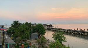 a bridge over a body of water next to a pier at Limlay House in Ban Suan On