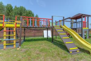 a playground with a slide in a park at Pylimo slėnis in Palanga