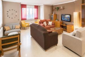 a living room with couches and chairs and a television at Casa Turística la Almunia in Castellanos de Moriscos