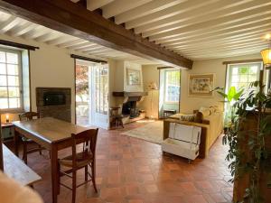 a living room with a couch and a table at charmante maison dans le Morvan in Lormes