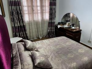 a bedroom with a bed and a vanity and a mirror at Dar Cirta in Sicca Veneria